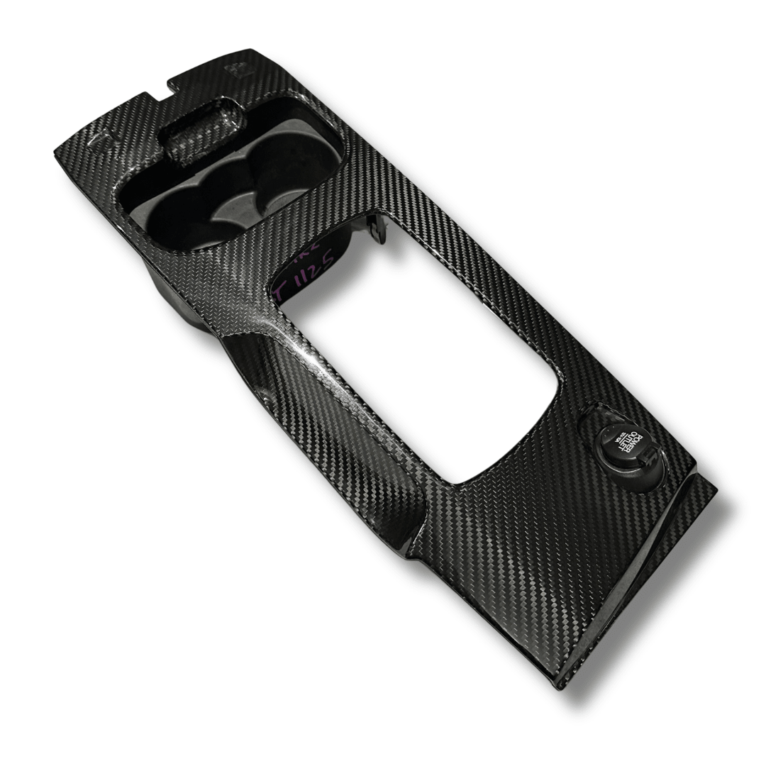 Gloss twill carbon fibre overlay on the Ford FG Falcon factory shifter surround with cup holders, angled view